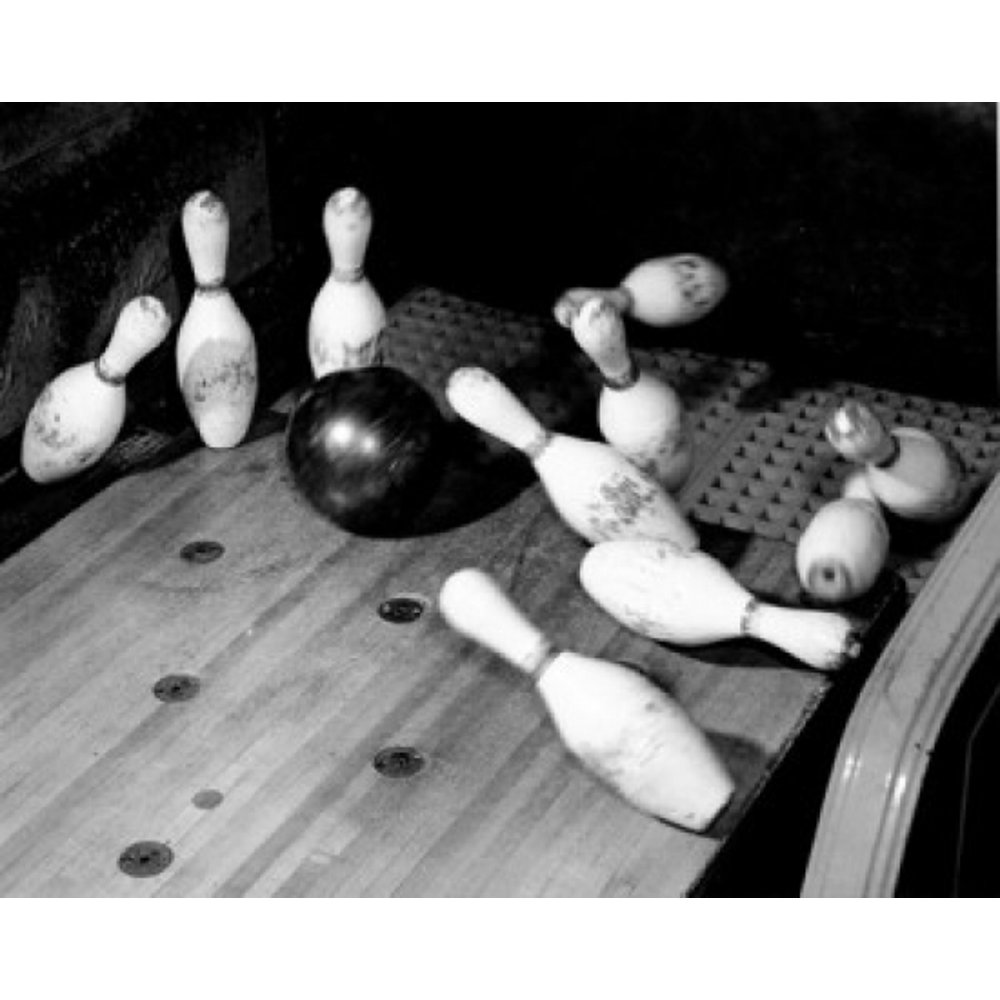 High angle view of a bowling ball knocking down bowling pins Poster