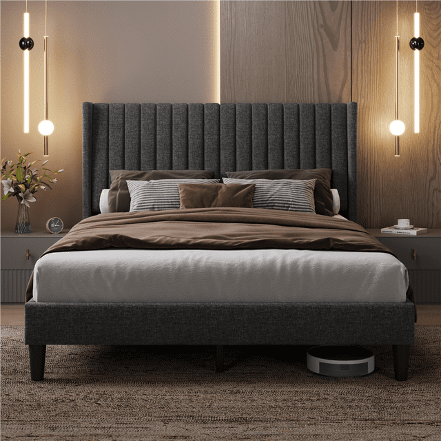 Fullfurnique dark gray queen upholstered bed frame featuring wing sides and a vertically channeled headboard, styled with pillows and brown bedding in a contemporary bedroom.