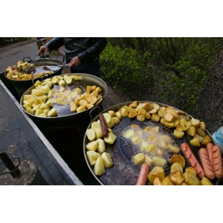 Vendor selling deep fried potatoes and sausages at a sidewalk food stall Old Town Dali Yunnan Province China Poster Print by Panoramic Images (36 x