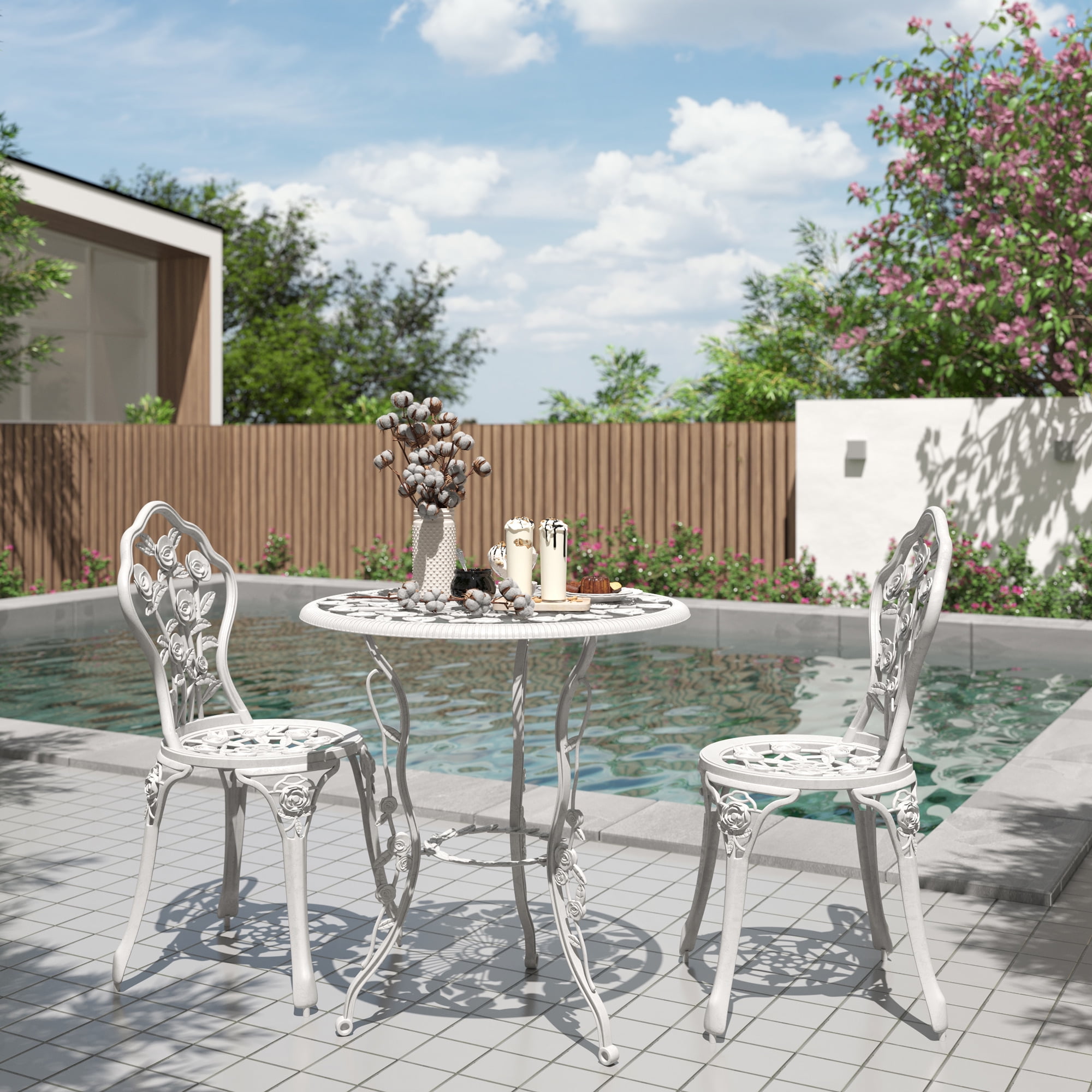 Image of White bistro patio set with round table and two metal chairs