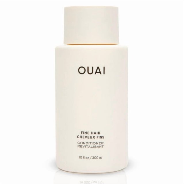 acondicionador voluminizador para cabello fino – con queratina y biotina, sin parabenos ni sulfatos Frasco cilíndrico frontal color crema mate con tapa de rosca y etiqueta minimalista; Verdeluxe formulado para aumentar volumen, suavidad y elasticidad en cabello fino, presentado sobre fondo blanco. A menudo usado para dar cuerpo adicional a mechones finos durante el peinado.