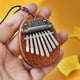 thumbnail image 4 of Mini piano de pulgar de 8 tonos kalinba madera maciza cristal transparente piano de cinco dedos piano de dedo portátil para principiantes estilo de instrumento musical, 4 of 5