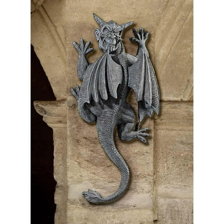 18  Medieval Gothic Dragon Gargoyle Wall Sculpture Statue Figurine Decor With tall horns  spiny claws and a menacing face  artist Liam Manchester s defiant demon gargoyle statue turns from his wall perch to taunt passersby with a look that reveals he is indeed  on the loose.  Stretching over a foot tall  our Design Toscano-exclusive gargoyle statue seems precipitously poised to transform from hand-painted  quality designer resin into flesh and blood at any moment! Another quality gargoyle statue from Toscano! 9 Wx4½ Dx18 H. 7 lbs.