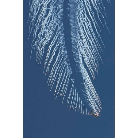 A Us Air Force Ac-130 Gunship Aircraft Executing An Evasive Maneuver And Dropping Chaff And ...