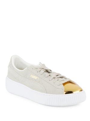 white pumas with gold tip