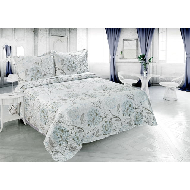 ultra soft summer quilt set featuring blue hydrangea floral printed embossed coverlet and matching shams on a bed in an elegant, light-filled bedroom