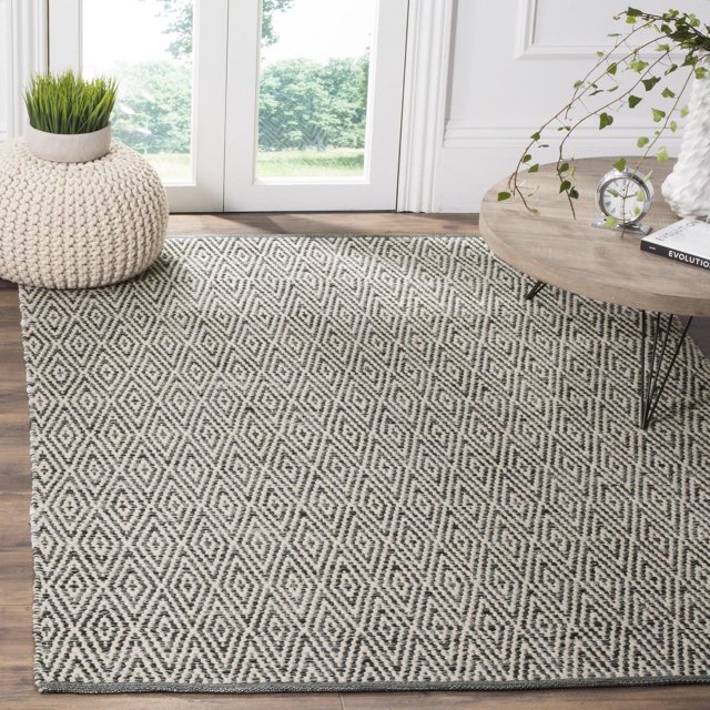 Safavieh Montauk Jakov geometric diamond pattern area rug in beige and black on wood floor with modern decor