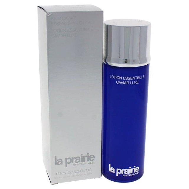 Skin Caviar Essence-In-Lotion by La Prairie for Unisex, a 5 oz facial treatment in a sleek cobalt blue bottle with a silver cap, displayed alongside its silver box packaging. Designed for morning and night use after cleansing and toning, this essence is applied by patting gently onto the face until fully absorbed.