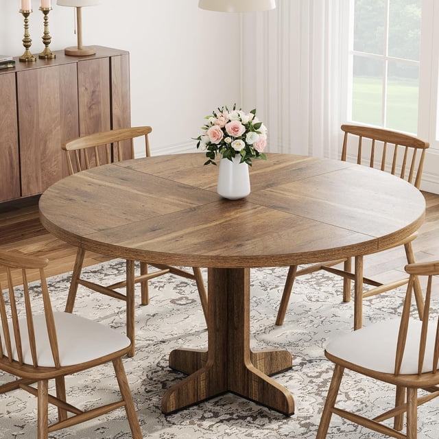 47 - pulgada round dining mesa para 4 - 6 people - kitchen y dining room circle dinner pedestal mesa con de madera pedestal base, space - saving, brown wood muebles vista frontal centrada de mesa de comedor redonda de 47 pulgadas con tablero de madera marrón rústico y base pedestal en cruz; tablero de 1.18 in MDF con vetas visibles, patas reforzadas y almohadillas antideslizantes ajustables, ubicada en comedor luminoso con cuatro sillas de madera y un jarrón con flores en el centro; ideal para estilos rústico y moderno y a menudo usada también como mesa multiusos para tareas ligeras o trabajo desde casa.