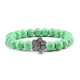 thumbnail image 1 of Pulsera con dije de huella de pata de piedra volcánica de lava negra mate natural, ideal como recuerdo para mascotas, amantes de los gatos y los perros., 1 of 2