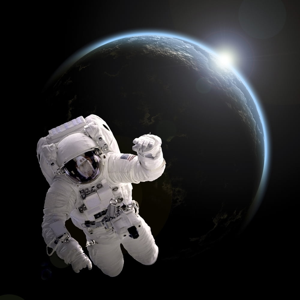 Astronaut floating in space as the sun rises on an Earthlike