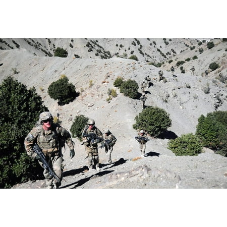 Infantrymen walk up a mountain trail in Afghanistan Poster Print by Stocktrek