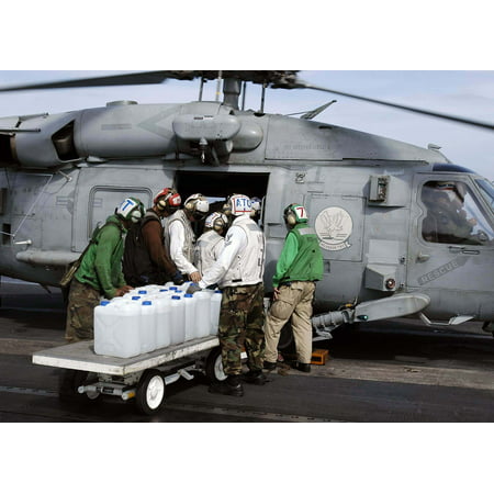 LAMINATED POSTER Sailor's aboard USS Abraham Lincoln (CVN 72) load jugs of purified water on board an awaiting HH-60H Poster Print 24 x