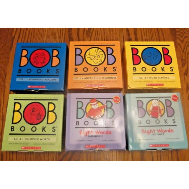 Bob Books Sight Words Kindergarten Box Set Decodable Phonics Books, Ages 4 and up, Kindergarten, Flashcards (Stage 2: Emerging Reader) showing six colorful boxed sets of Bob Books arranged on a wooden surface, each box labeled with reading stages from beginning readers to first grade, featuring cartoon illustrations and Scholastic branding, suitable for early literacy learning.