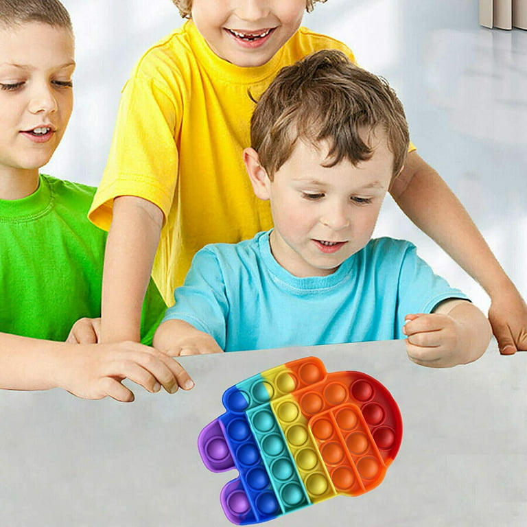 Premium Photo  Little child playing with rainbow pop it fidget gadget that  is a popular silicone anti stress toy