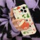 thumbnail image 4 of Funda navideña compatible con iPhone 14, diseño navideño con estampado geométrico rojo y verde, con calcetines navideños de dibujos animados, Pop Socket para mujeres y niñas., 4 of 8