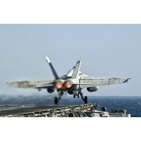 A US Navy FA-18F Super Hornet launches from the flight deck of aircraft carrier USS Nimitz Poster