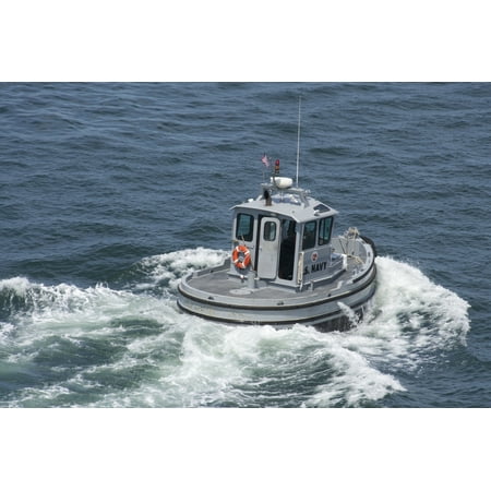 Brass Pier Base September 4 2012 - A Navy working boat moves back to its mooring after pulling the pier guard fence into position at Naval Base San Diego Poster Print ()