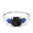 thumbnail image 2 of Gem Stone King 10K White Gold Black Onyx and Blue Created Sapphire 3-Stone Engagement Ring for Women (2.01 Cttw, 7MM Cushion Checkerboard and 4MM Trillion, Size 9), 2 of 6