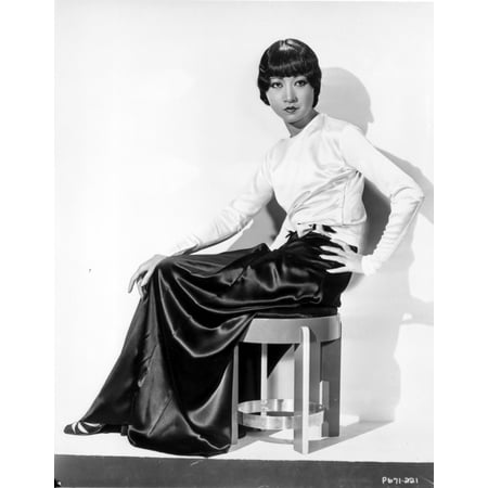 Anna Wong sitting on the Chair Hand on Hips Photo