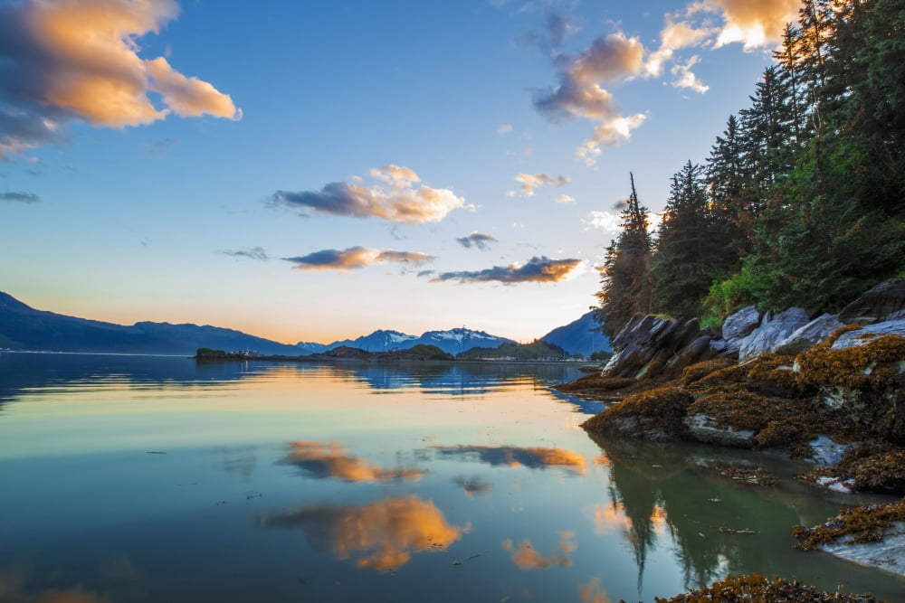 The sun colors the clouds pink as it sets in the Northwest while looking down Port Valdez from Dock Point at low tide Valdez Alaska United States of America Canvas Art - Zachary Sheldon Design Pics (