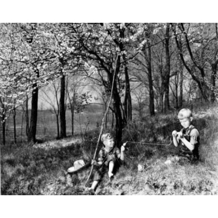 vintage photograph of boys with improvised fishing rod putting bait