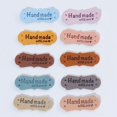thumbnail image 1 of 100 piezas etiqueta colorida hecha a mano amor dos agujeros en relieve etiqueta de cuero de gamuza sombrero bolso hecho a mano ropa, 1 of 5