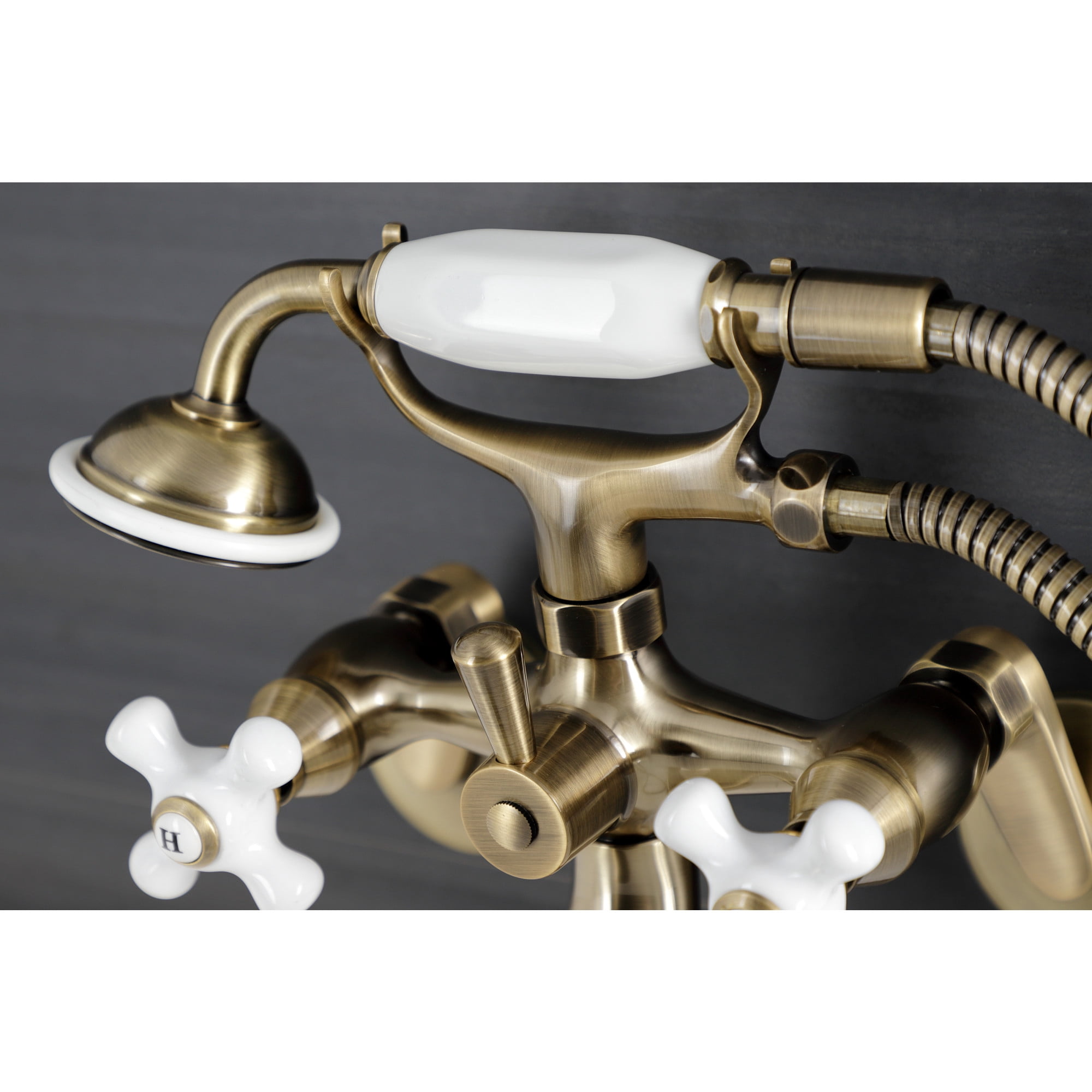Kingston Brass KS226PXAB Kingston Three-Handle 2-Hole Wall Mount Clawfoot Tub Faucet with Hand Shower in Antique Brass