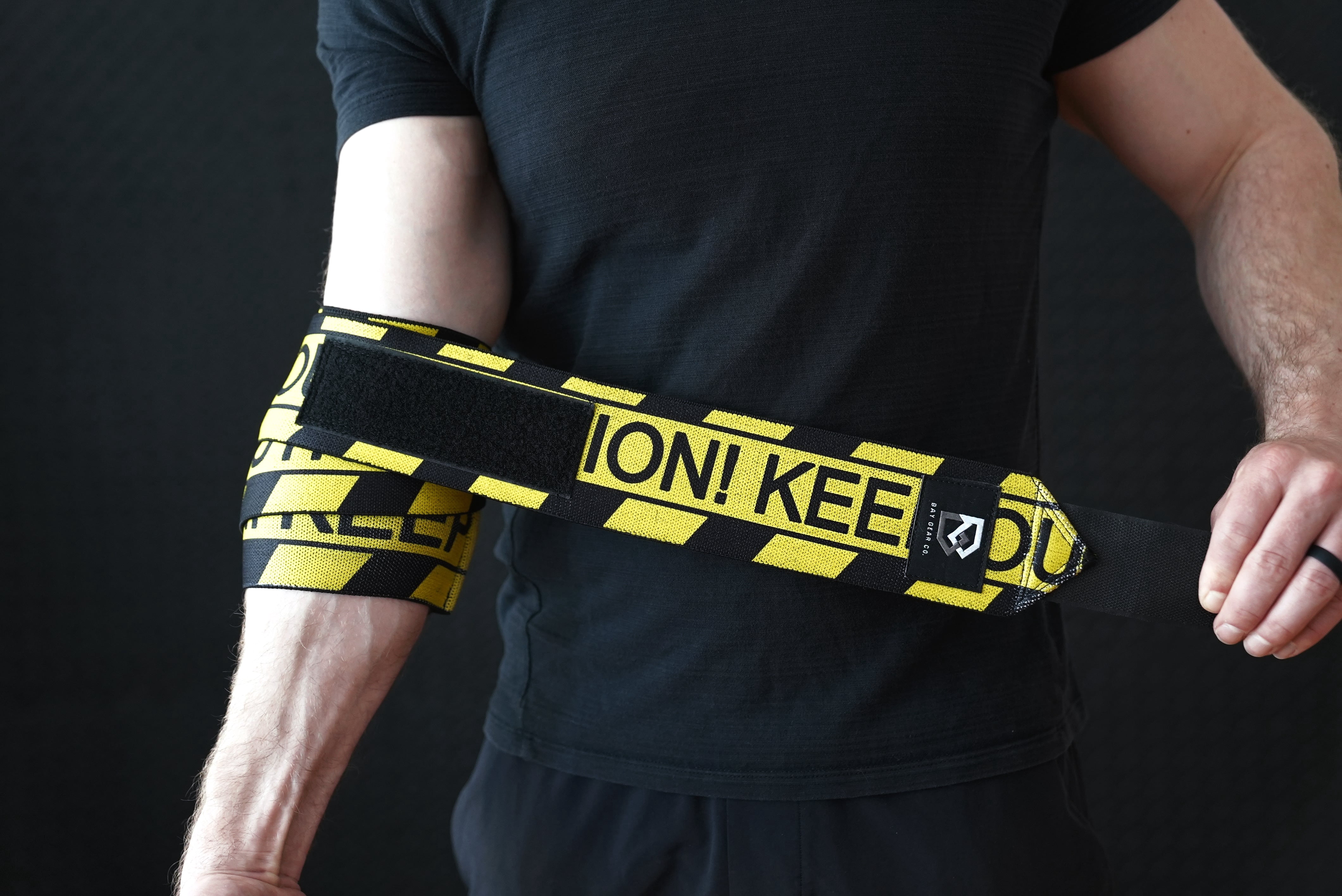 Bay Gear Co. Weightlifting Elbow Wraps (1 Pair) - Flexible Elbow Compression Strap & Joint Support Brace - For Bench Press, Powerlifting, Overhead Pressing and Heavy Lifts - Caution