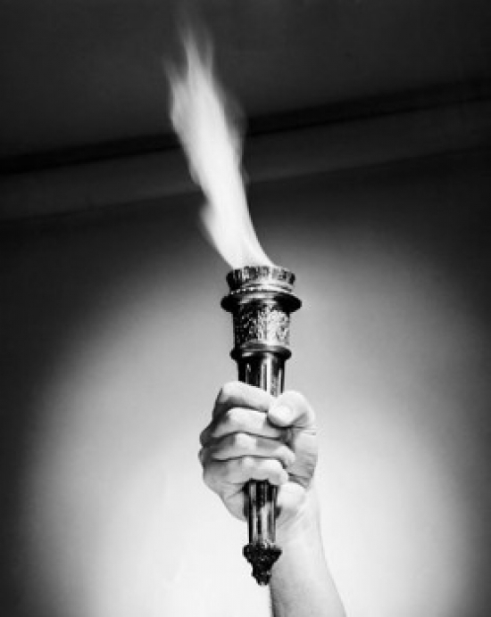 Closeup of a person's hand holding a flaming torch Poster Print (18 x