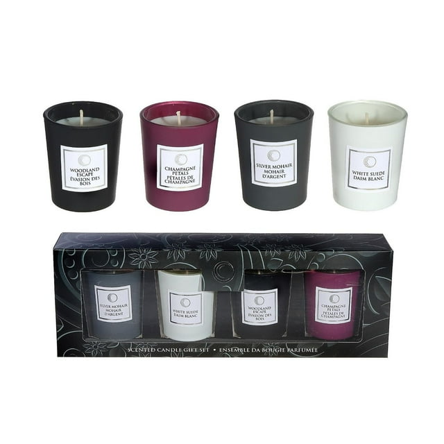 Set of four 2.5 oz luxe scented glass candles in black, purple, dark gray and white holders labeled Woodland Escape, Champagne Petals, Silver Mohair and White Suede with decorative gift box.