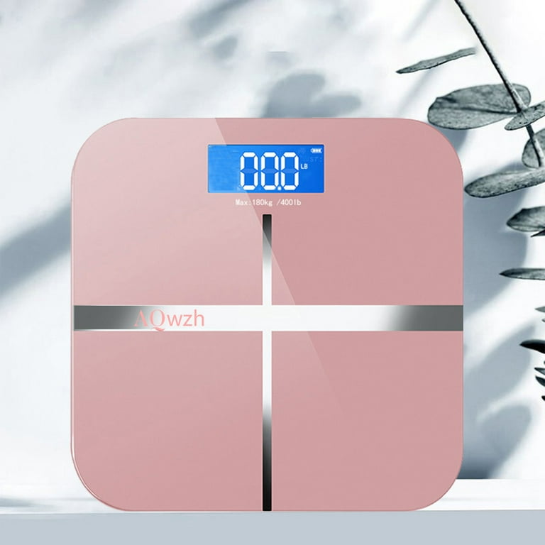 Measure tape with dumbbells and weight scale on the pink
