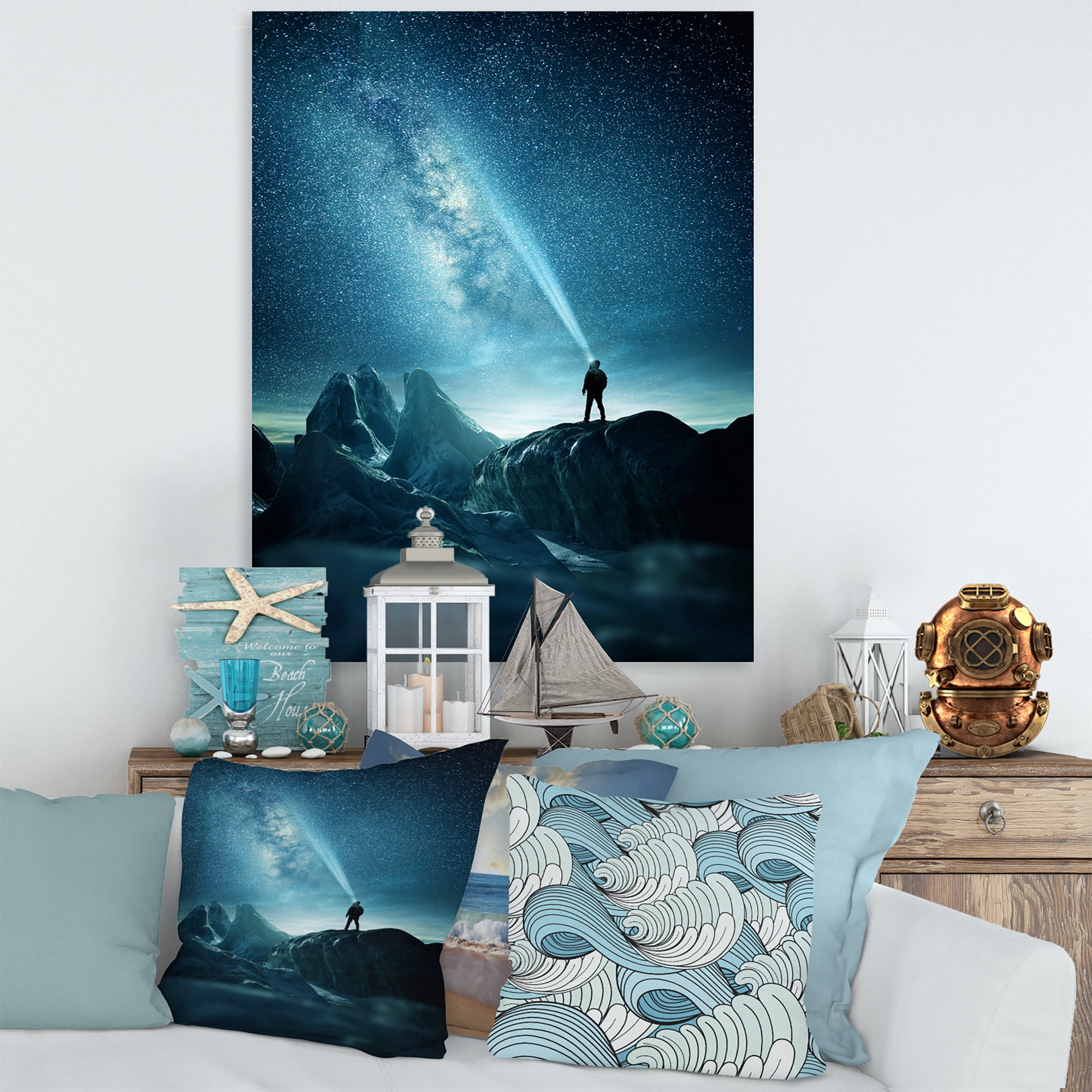 A Light Shining by A Man Shining Into The Night Sky 12 in x 8 in Photography Canvas Art Print, by Designart