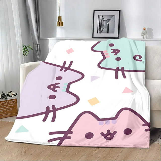 The Cat Cute Pusheens Printed Blanket by DENGLE, featuring a playful design of pastel-colored cat faces and geometric shapes on a white background. Made from 100% polyester, this soft and comfortable blanket is available in multiple sizes, including 76x102cm (30x40in) and 152x203cm (60x80in). Suitable for travel, home decor, or bedding, it is displayed draped over a sofa in a cozy, modern living room setting.