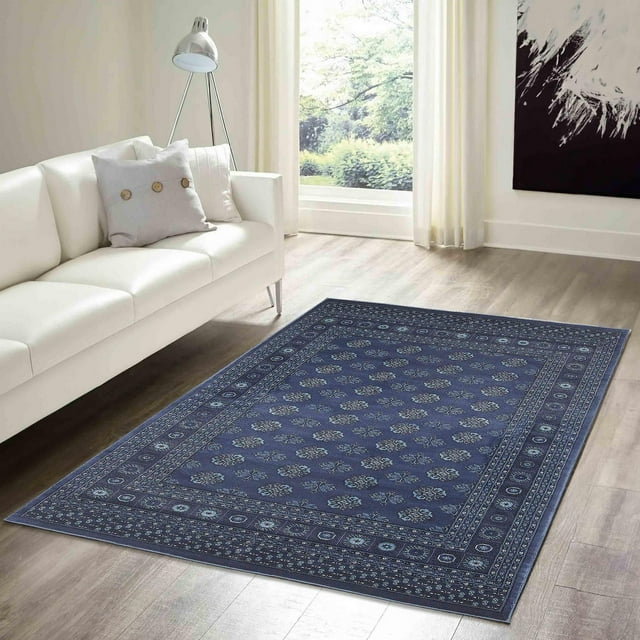 Blue ECARPET Bokhara Oriental area rug with detailed floral motifs on wooden floor in a modern living room setting.