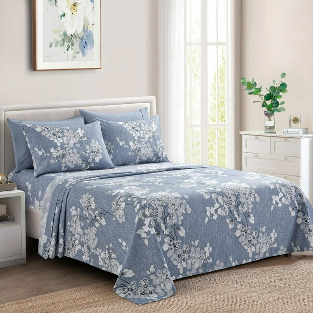 blue deep pocket sheet set with romantic white and gray floral pattern on bed in modern room