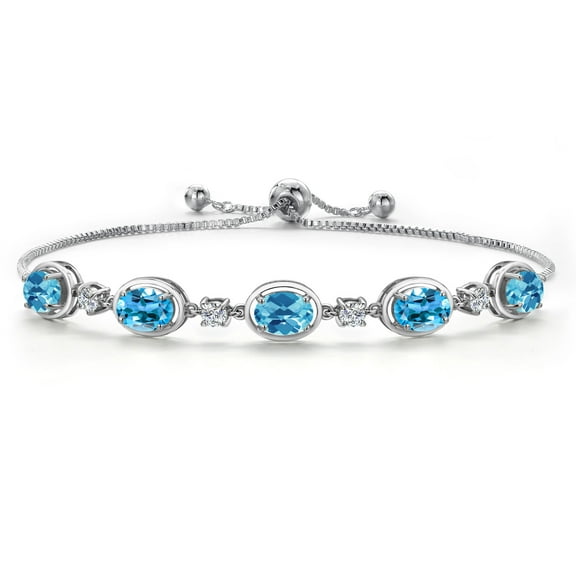 Gem Stone King 925 Sterling Silver Swiss Blue Topaz and Moissanite Tennis Bracelet for Women | 5.00 Cttw | Gemstone November Birthstone | Oval Checkerboard 7X5MM | Fully Adjustable 10 inch