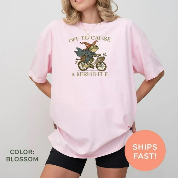 Off to Cause a Kerfuffle T-Shirt – Cute Witchy Frog Riding Bicycle Graphic Tee for Whimsical Souls & Cottagecore Lovers