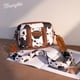 thumbnail image 2 of Bandolera Wrangler con estampado de vaca para mujer, color marrón Montana West, 2 of 6