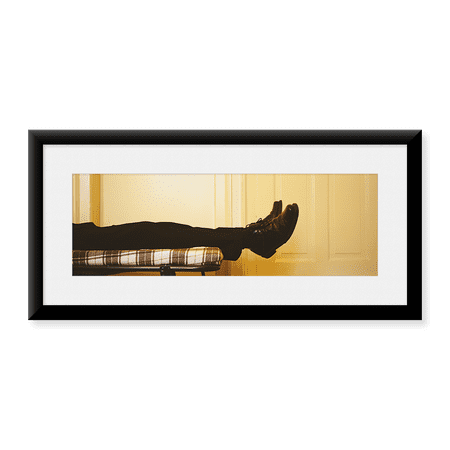 Framed Art Print, Low Section View Of A Man Lying On The Bed by Panoramic Images, 25-7/8" x 9-7/8"