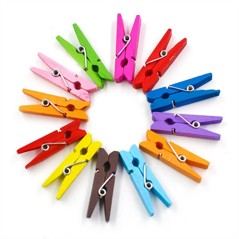 Concept image of tiny clothespins holding different color notes on