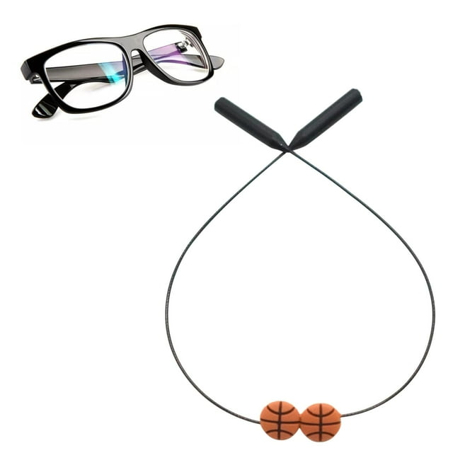 cuerda para sujetar gafas macarena para anteojos deportivos baloncesto correa de silicona con alambre de acero interno y dos cuentas naranjas con dibujo de balón; vista frontal centrada de la cuerda negra con fundas de silicona en los extremos, longitud máx. 35 cm (13.78 in), adecuada para sujetar monturas alrededor del cuello y evitar caídas, a menudo usada también como retenedor deportivo para actividades.