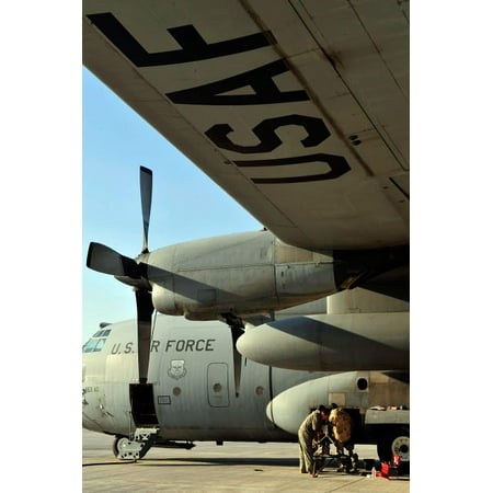 Mechanics change an auxiliary power unit of a C-130 Hercules Poster Print by Stocktrek