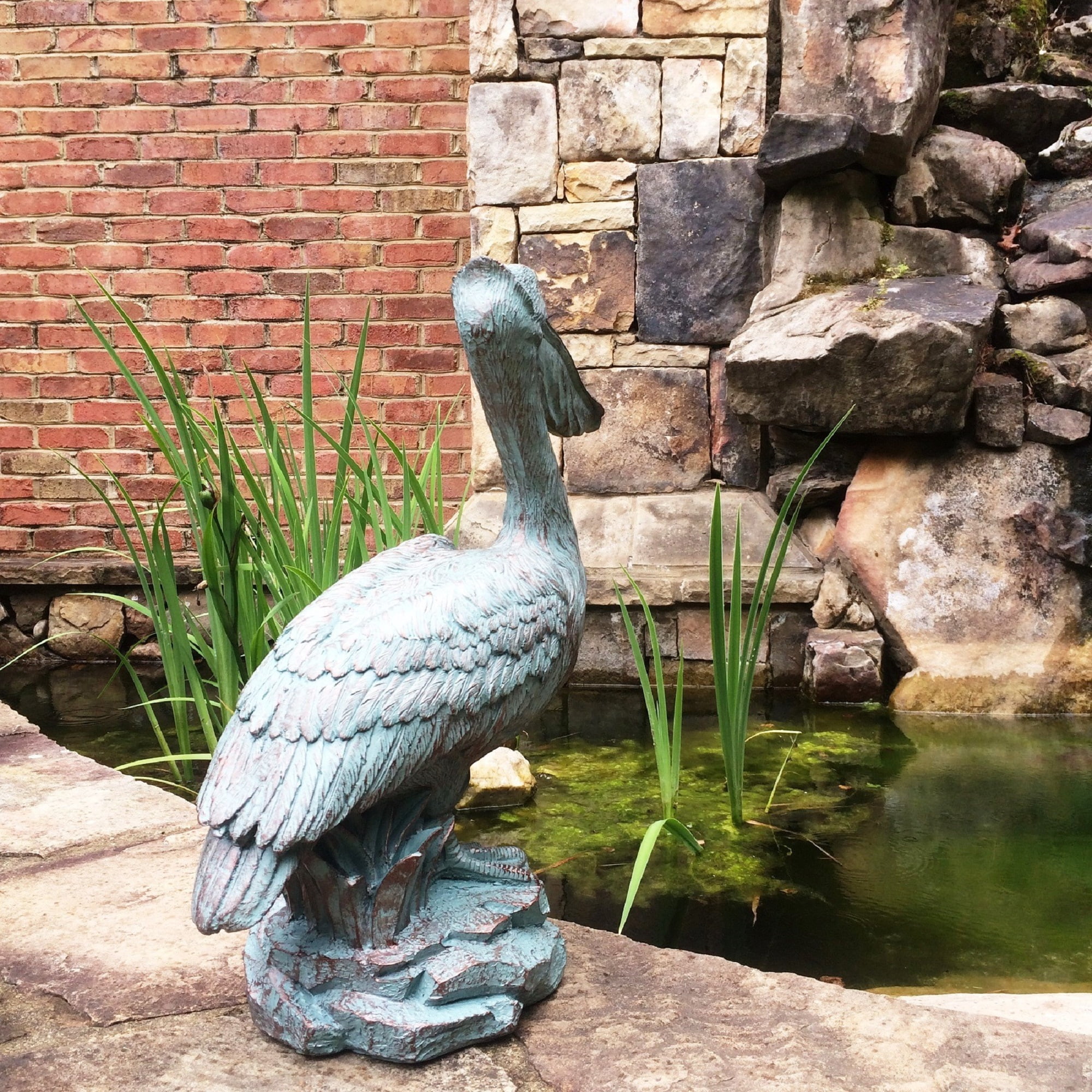 Homestyles 20 in. Bronze Patina Pelican on Coastal Rock Beach Statue