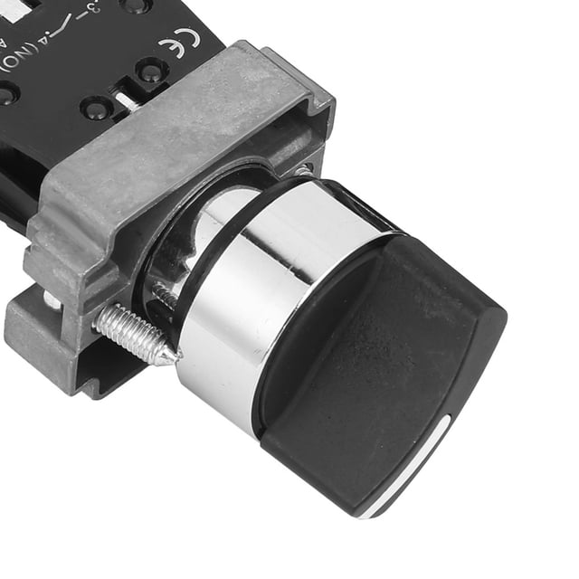 interruptor de perilla nc, interruptores de botón duraderos de resistencia a altas temperaturas de 10 piezas, alto impulso para botón de máquina — primer plano frontal oblicuo de interruptor de perilla NC montado en marco metálico; carcasa de ABS negra, casquillo cromado brillante, perilla negra con ranura blanca, tornillo de sujeción y base de contactos eléctricos visibles; diseñado para panel eléctrico y control de circuitos, también adecuado para paneles de maquinaria.