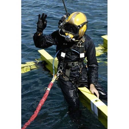 February 1 2007 - US Navy Diver signals an OK sign to the dive supervisor on a dive station off the coast of Aimeliik Republic of Palau after securing bolts onto a support beam Poster