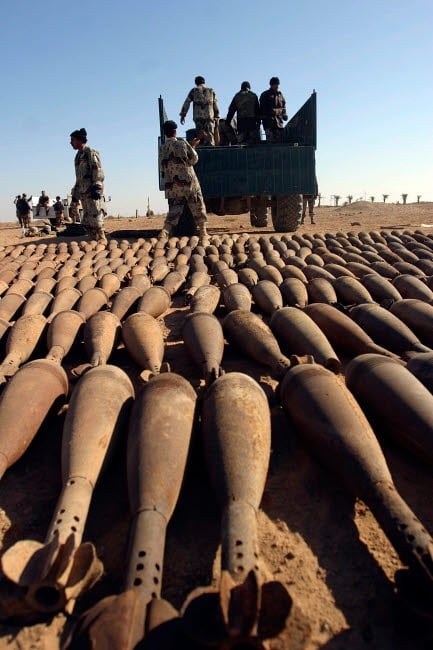 Soldiers load 120 millimeter white phosphorous mortar rounds onto an ...