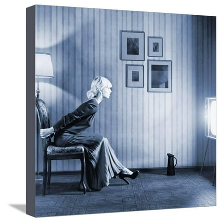 Young Woman Sitting on a Chair in Vintage Interior and Watching Retro TV Stretched Canvas Print Wall Art By
