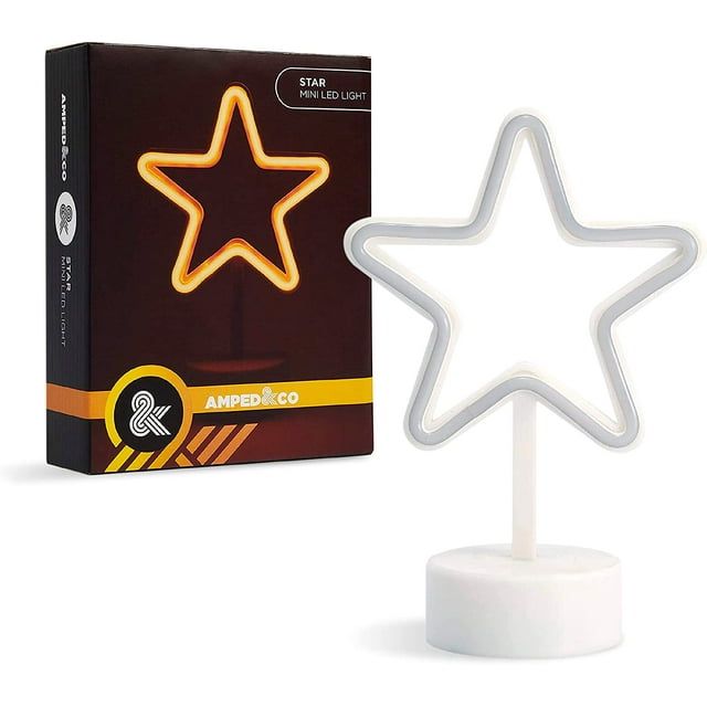 Amped & Co Star LED Light, a 7x5-inch neon desk sign in a star shape, glowing vibrant yellow. The light is battery-operated and features a white base, ideal for tabletop or desktop use. The packaging is visible in the background, showcasing the product's design and branding.