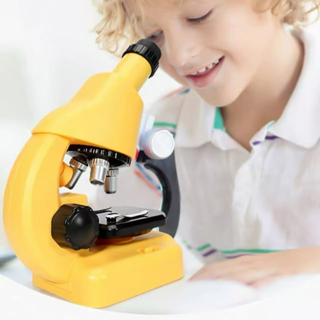TIMIFIS Science Microscope Children's Microscope Toys HD 1200 Times DIY Biological Experiment Glass Educational Science Toys. A bright yellow plastic microscope with a black adjustable platform, large focus knob, and three magnification levels (40x-1200x). Includes LED lighting for viewing translucent specimens. Suitable for children aged 3 and up, ideal for educational experiments and STEM learning. Shown on a white surface.